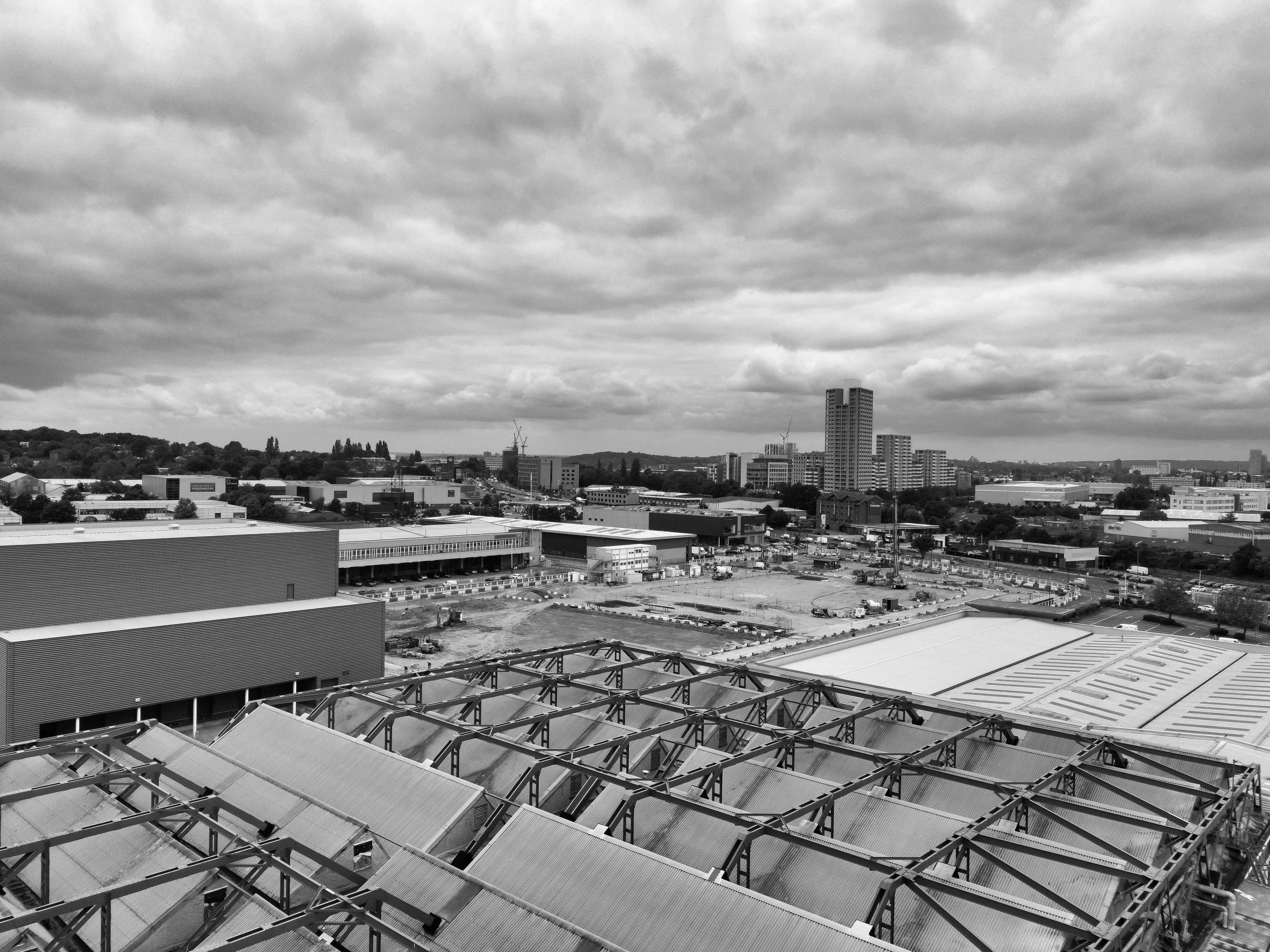 Black and white drone view of facility from sky.