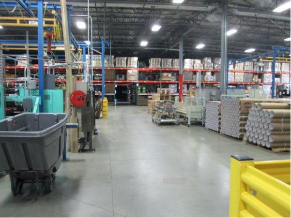 Palletizing and Warehousing image, clean floor, storage racks on backwall, cardboard core rolls for rollstock