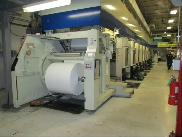 Rotogravure Press in profile, ink towers and roller stations depicted behind the control module